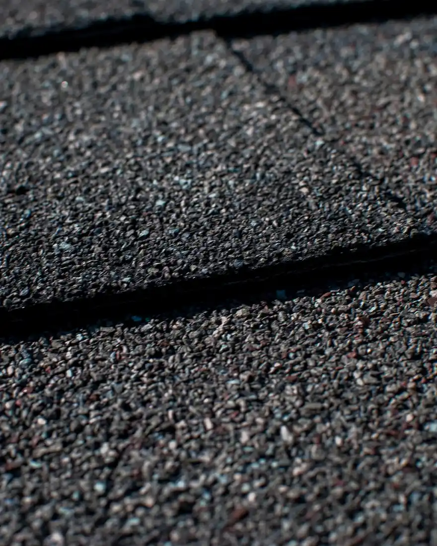 Close-up of new dark asphalt shingles with crisp edges